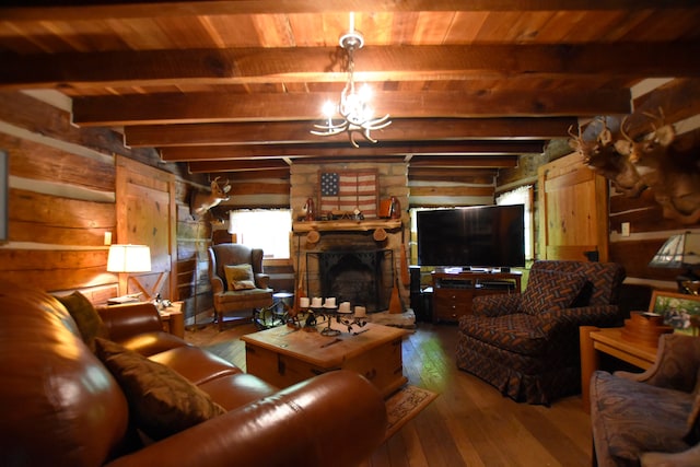 living room with a notable chandelier, beam ceiling, a fireplace, log walls, and dark hardwood / wood-style flooring