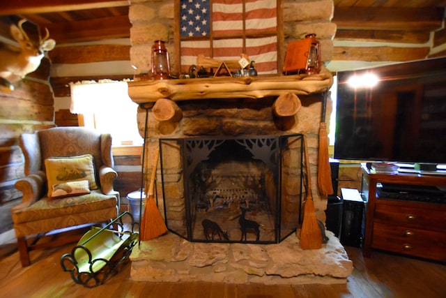 living room featuring a fireplace, beamed ceiling, and hardwood / wood-style flooring