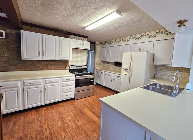 kitchen featuring white fridge with ice dispenser, sink, light wood-type flooring, and electric range