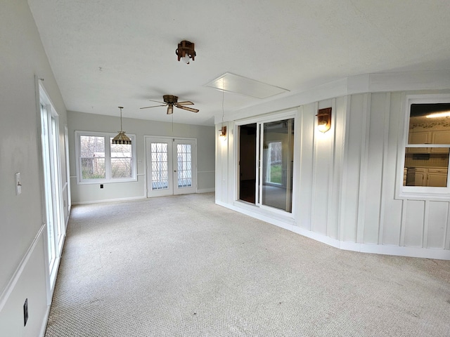 unfurnished room with ceiling fan and light carpet