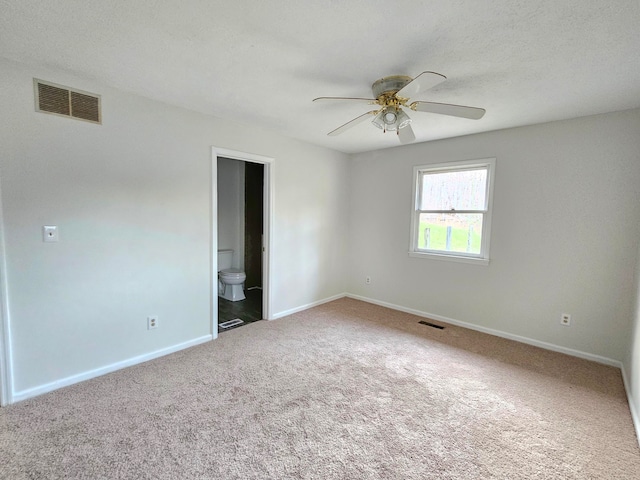 unfurnished room with carpet flooring, a textured ceiling, and ceiling fan