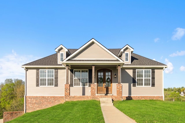 view of front facade featuring covered porch and a front lawn