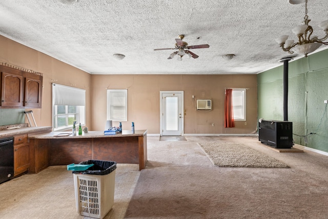 kitchen with light carpet, a wood stove, ceiling fan, and a textured ceiling