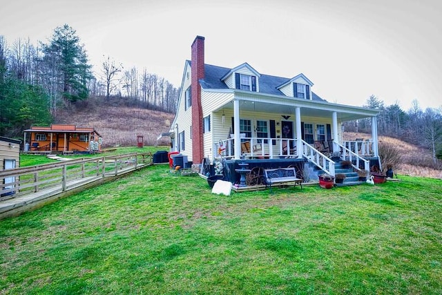 rear view of property with a lawn and covered porch