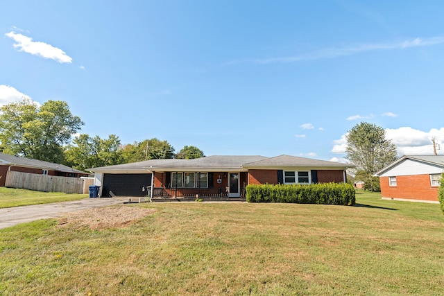 single story home featuring a porch, a garage, and a front yard