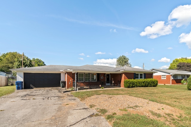 ranch-style house featuring a garage, a porch, and a front lawn