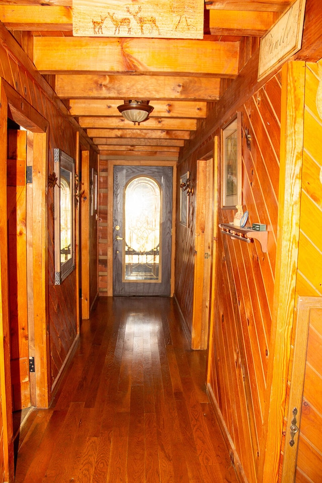 corridor featuring beam ceiling and hardwood / wood-style floors