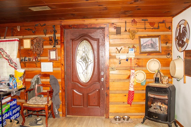 foyer entrance featuring wood walls, light hardwood / wood-style floors, and wooden ceiling