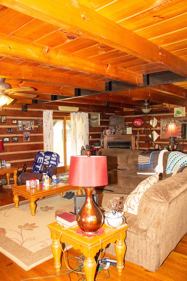 living room featuring ceiling fan, beamed ceiling, hardwood / wood-style floors, and wood ceiling