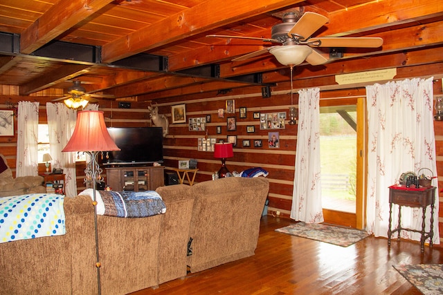 living room featuring ceiling fan, beamed ceiling, hardwood / wood-style floors, and wooden ceiling