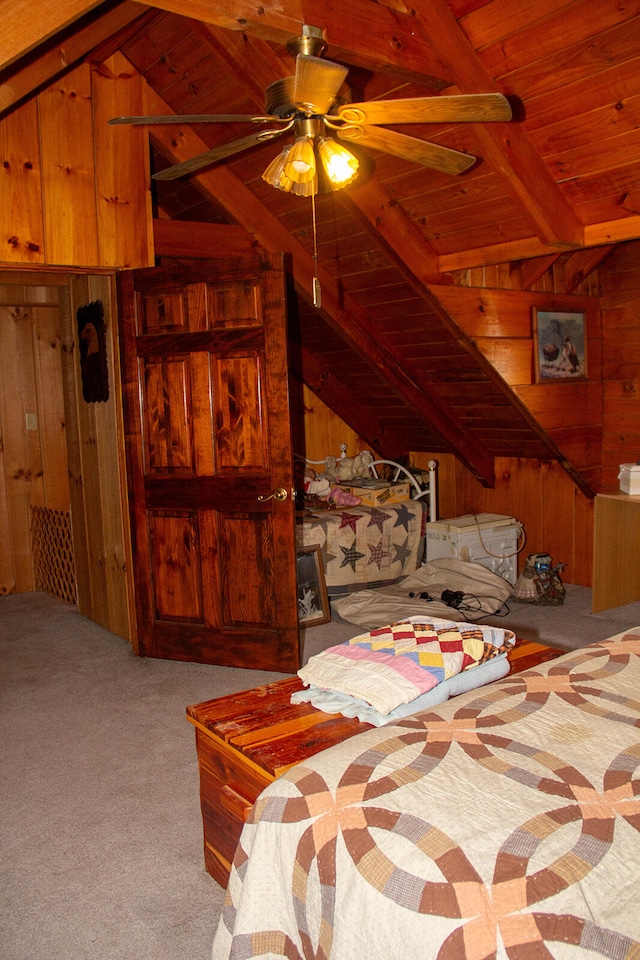 bedroom with vaulted ceiling with beams, carpet, wooden ceiling, wooden walls, and ceiling fan