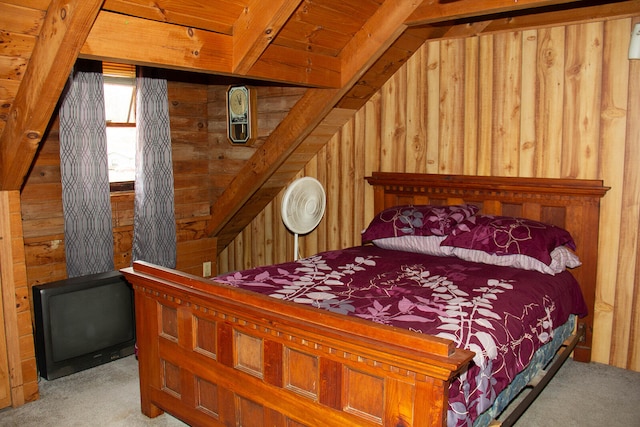 bedroom featuring light carpet and wood walls