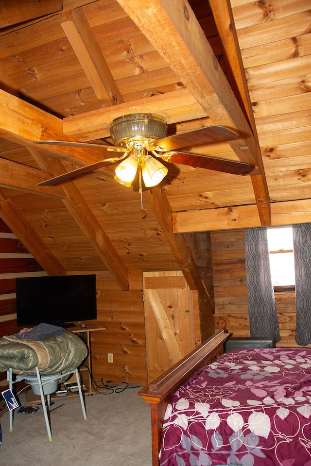 bedroom with wood ceiling, carpet floors, ceiling fan, and wood walls