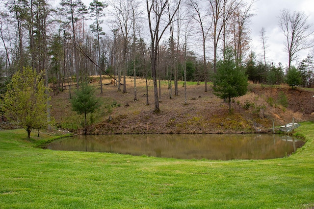 exterior space featuring a lawn and a water view