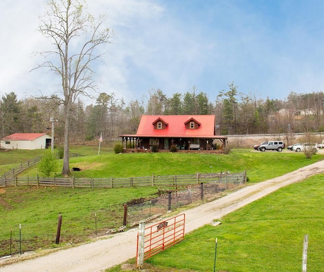 view of property's community featuring a rural view and a yard