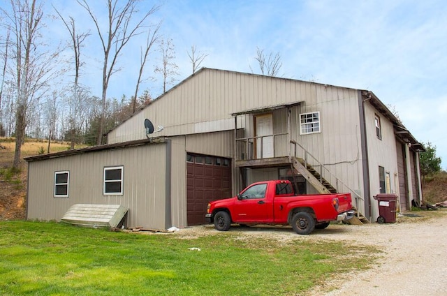 view of outbuilding with a lawn and a garage