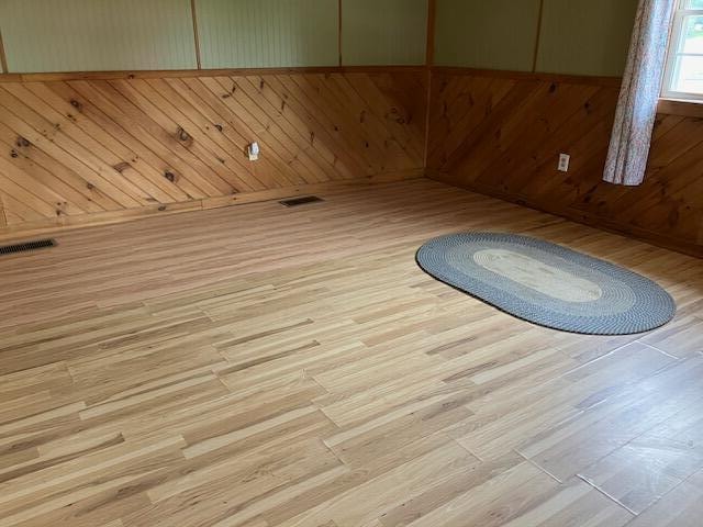 unfurnished room with light wood-type flooring