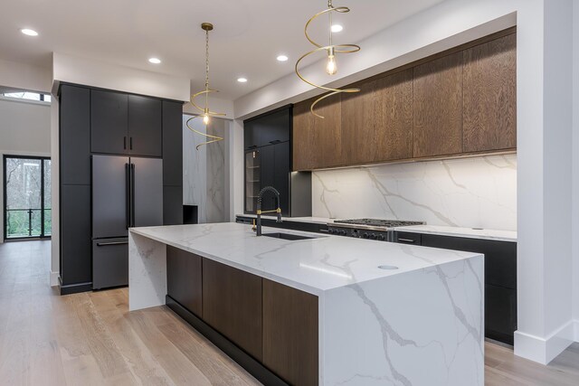 2420 Flying Ebony Dr, Lexington, KY 40509 - kitchen featuring built in refrigerator, hanging light fixtures, a sink, and modern cabinets