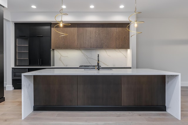 2420 Flying Ebony Dr, Lexington, KY 40509 - kitchen featuring modern cabinets, wall oven, a sink, decorative light fixtures, and light stone counters