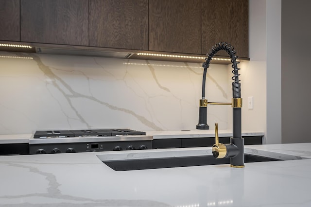 2420 Flying Ebony Dr, Lexington, KY 40509 - details with light stone countertops, dark brown cabinets, and decorative backsplash