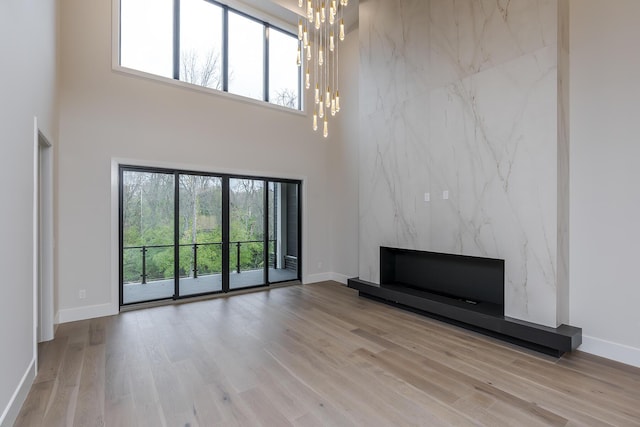 2420 Flying Ebony Dr, Lexington, KY 40509 - unfurnished living room with baseboards, wood finished floors, and an inviting chandelier