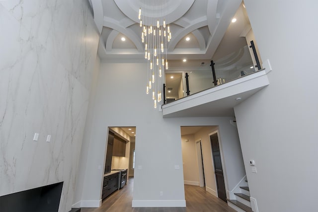 2420 Flying Ebony Dr, Lexington, KY 40509 - living room with wood finished floors, a towering ceiling, recessed lighting, and an inviting chandelier