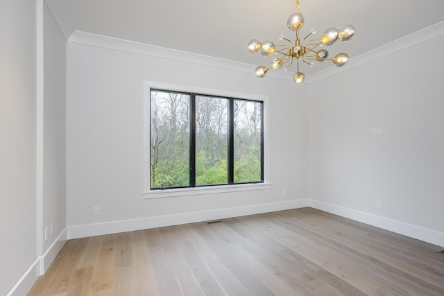 2420 Flying Ebony Dr, Lexington, KY 40509 - unfurnished room featuring baseboards, ornamental molding, wood finished floors, and a notable chandelier