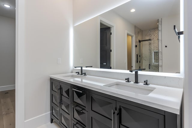 2420 Flying Ebony Dr, Lexington, KY 40509 - bathroom featuring a stall shower, double vanity, recessed lighting, and a sink
