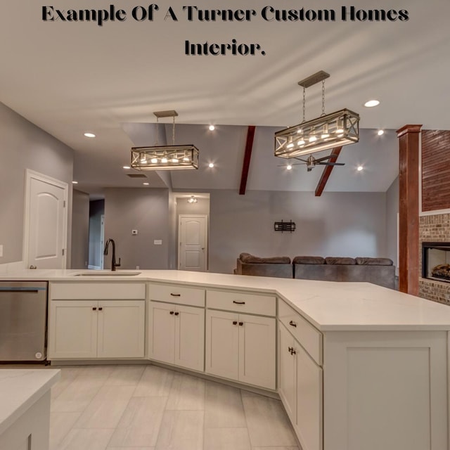 kitchen with sink, light stone counters, dishwasher, a fireplace, and decorative light fixtures