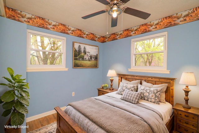 bedroom with baseboards and wood finished floors