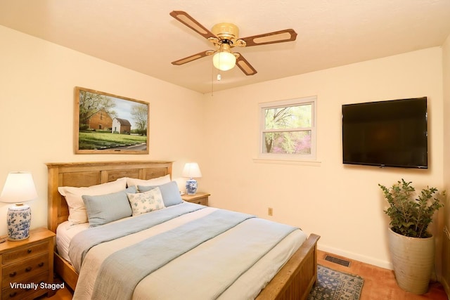 bedroom with baseboards, visible vents, and a ceiling fan