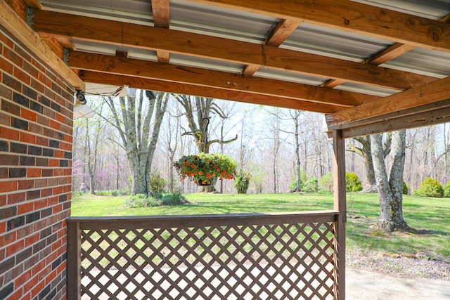 wooden terrace with a lawn