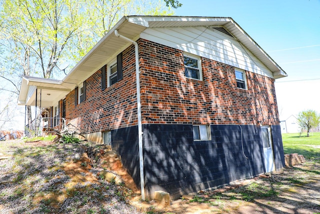 view of side of home with brick siding