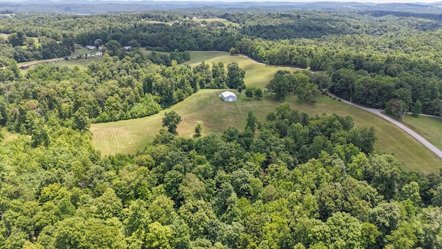 birds eye view of property featuring a view of trees