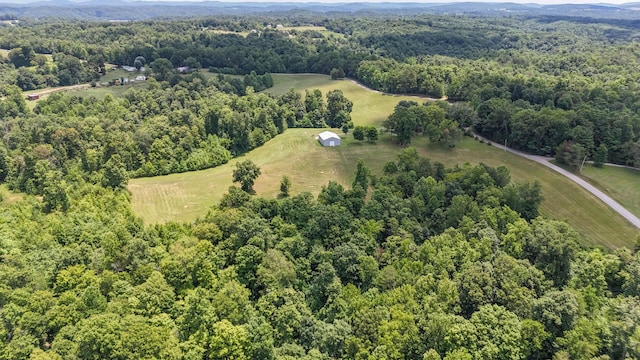 birds eye view of property featuring a view of trees