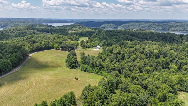 drone / aerial view featuring a water view and a wooded view