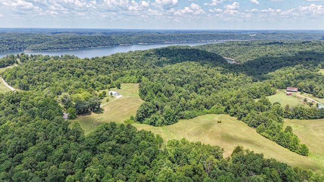 drone / aerial view featuring a water view and a wooded view