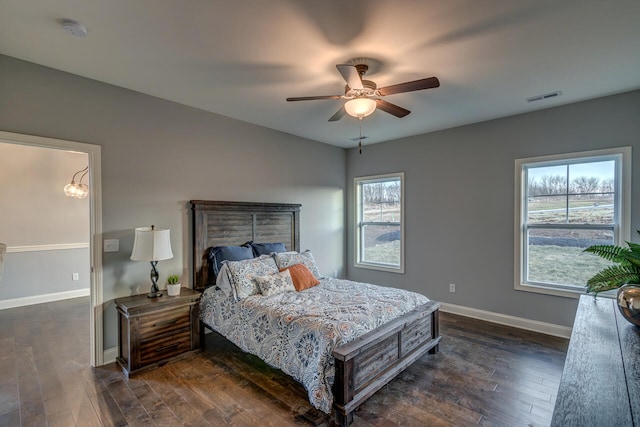 bedroom with ceiling fan and dark wood-type flooring