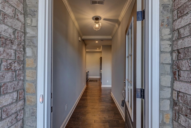 hallway with ornamental molding and dark hardwood / wood-style flooring