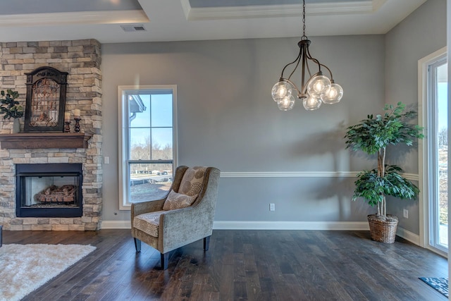 sitting room featuring a notable chandelier, dark hardwood / wood-style floors, a tray ceiling, and plenty of natural light