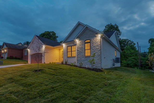 view of front of property featuring a front lawn and a garage