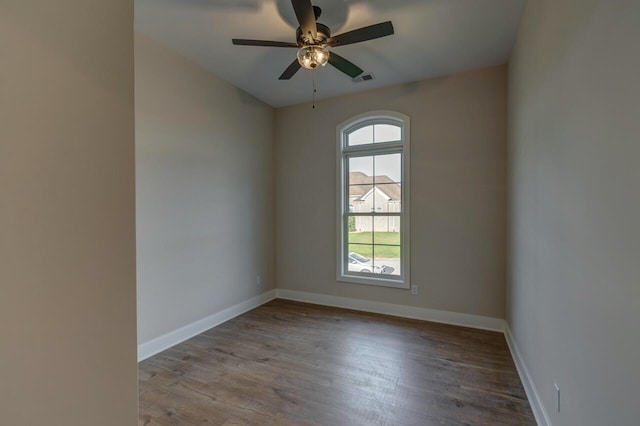 empty room with ceiling fan and hardwood / wood-style floors