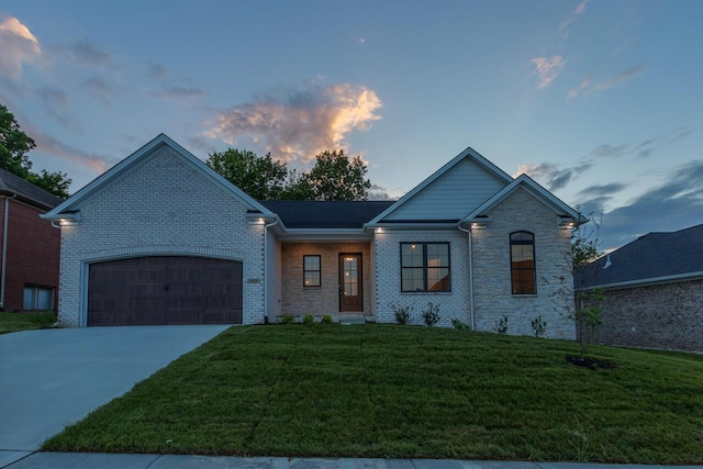 view of front of home with a lawn and a garage