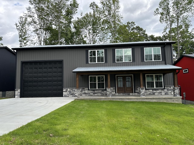 view of front of property featuring a porch, a garage, and a front lawn