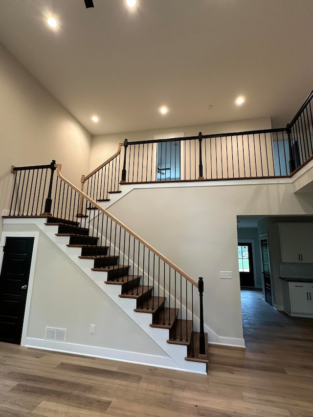 staircase featuring wood-type flooring