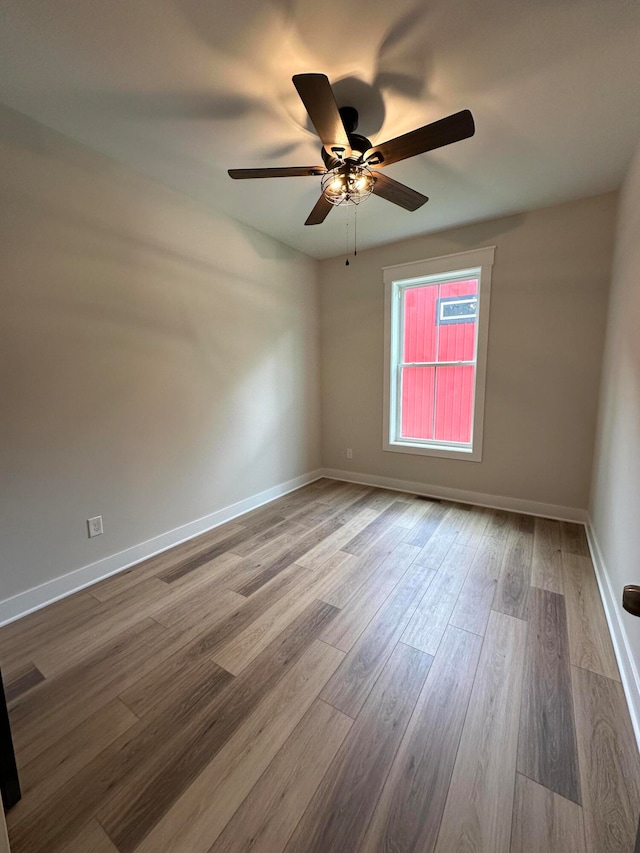 unfurnished room with hardwood / wood-style flooring and ceiling fan