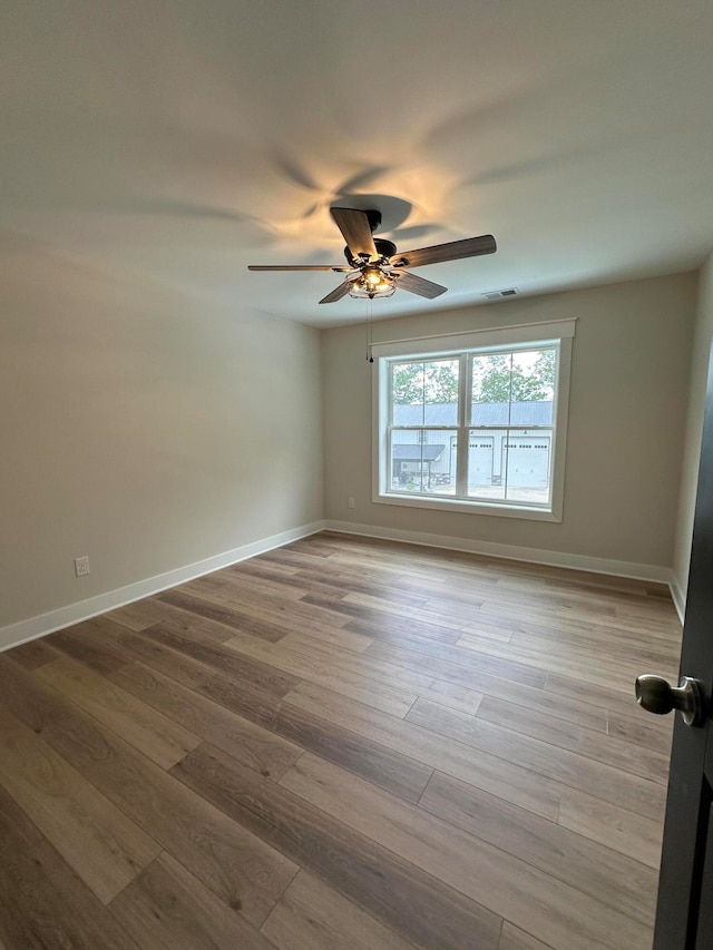 spare room featuring light hardwood / wood-style flooring and ceiling fan