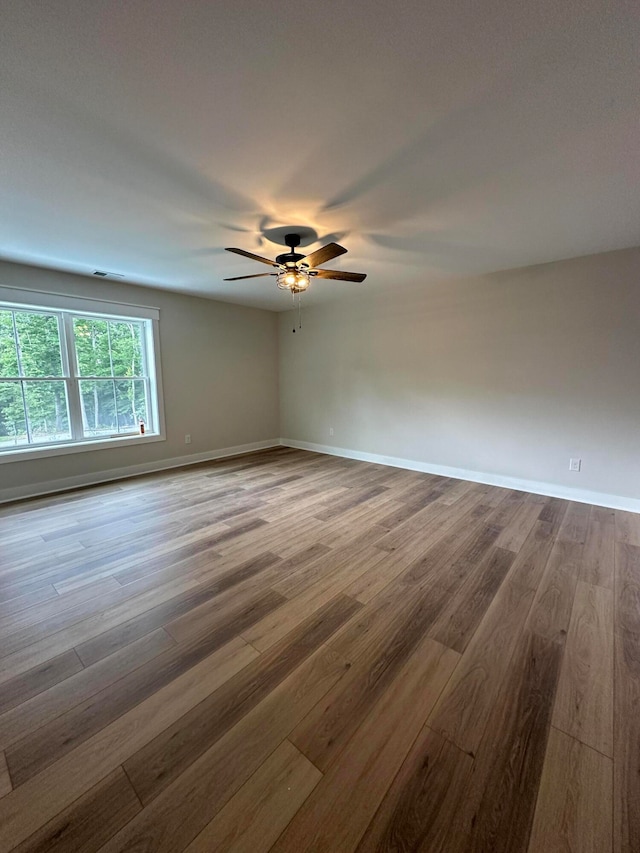 unfurnished room with ceiling fan and wood-type flooring