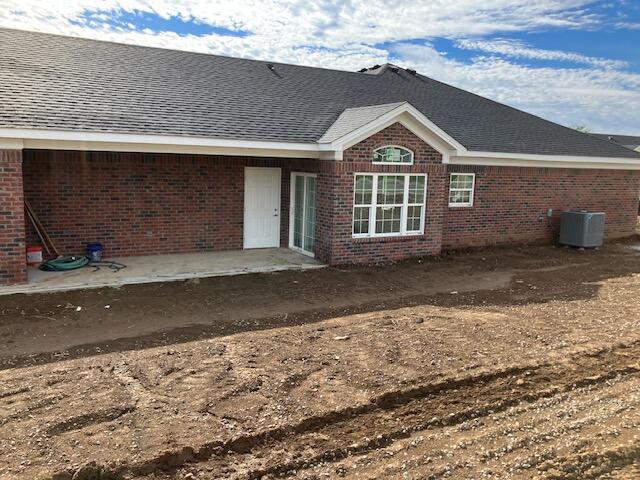 back of property featuring central air condition unit and a patio area