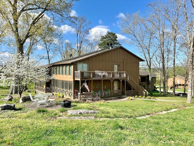 rear view of property featuring a lawn